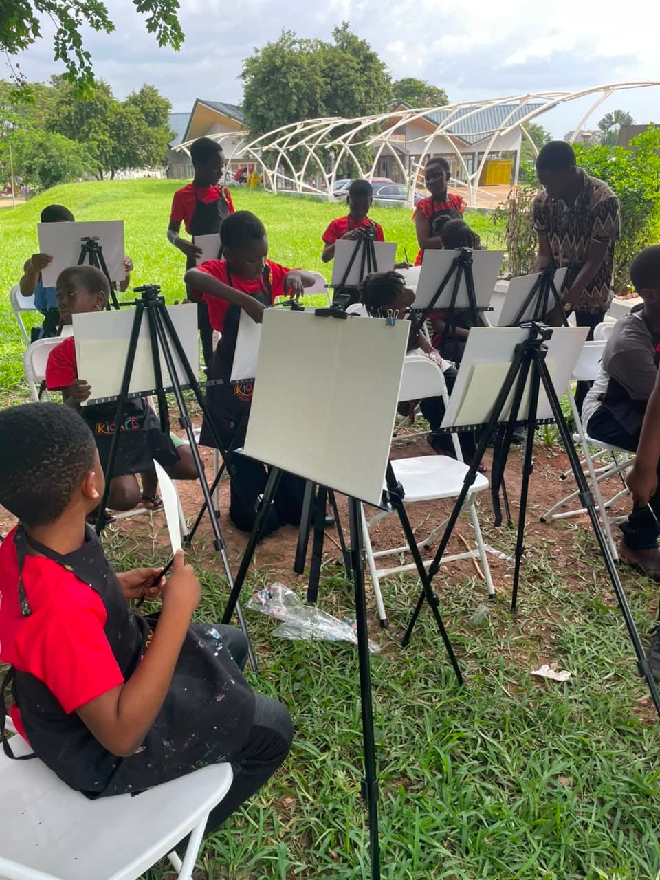 A Thrive EDU student painting outdoors at an art workshop